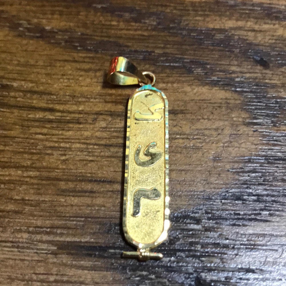 Gold plated hieroglyphic Kim pendant.